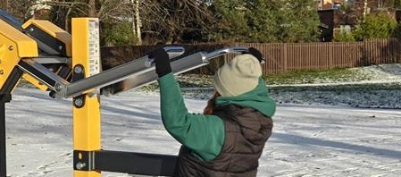 henkilö ulkokuntosalilla pystypunnertamassa